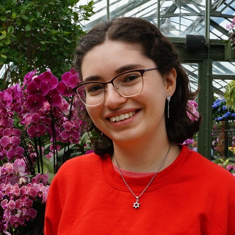 Image of Baila Hantsis. She has brown hair, glasses, and a star of david necklace.